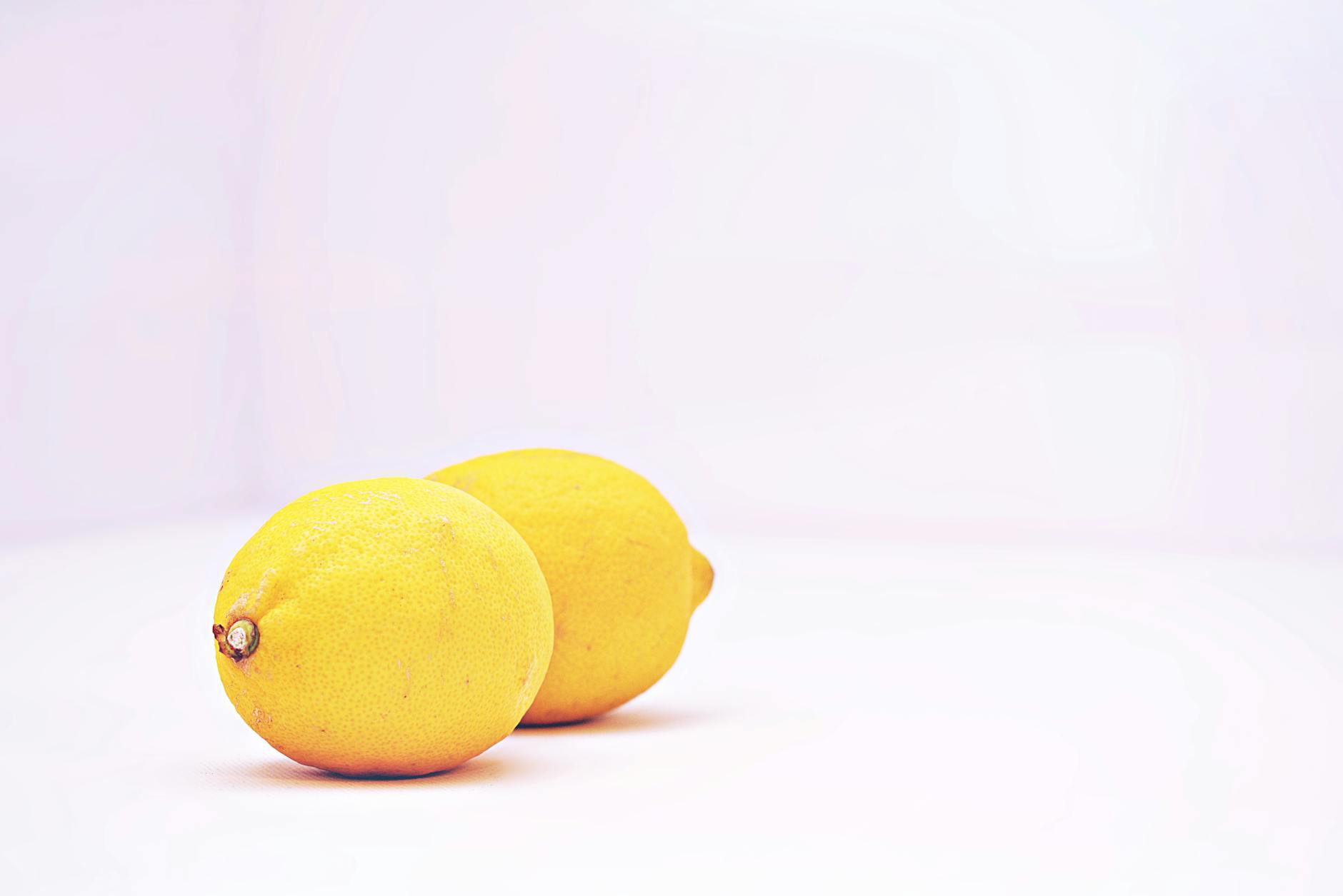 Two vibrant lemons on a white background, symbolizing fresh sensation and sensitivity