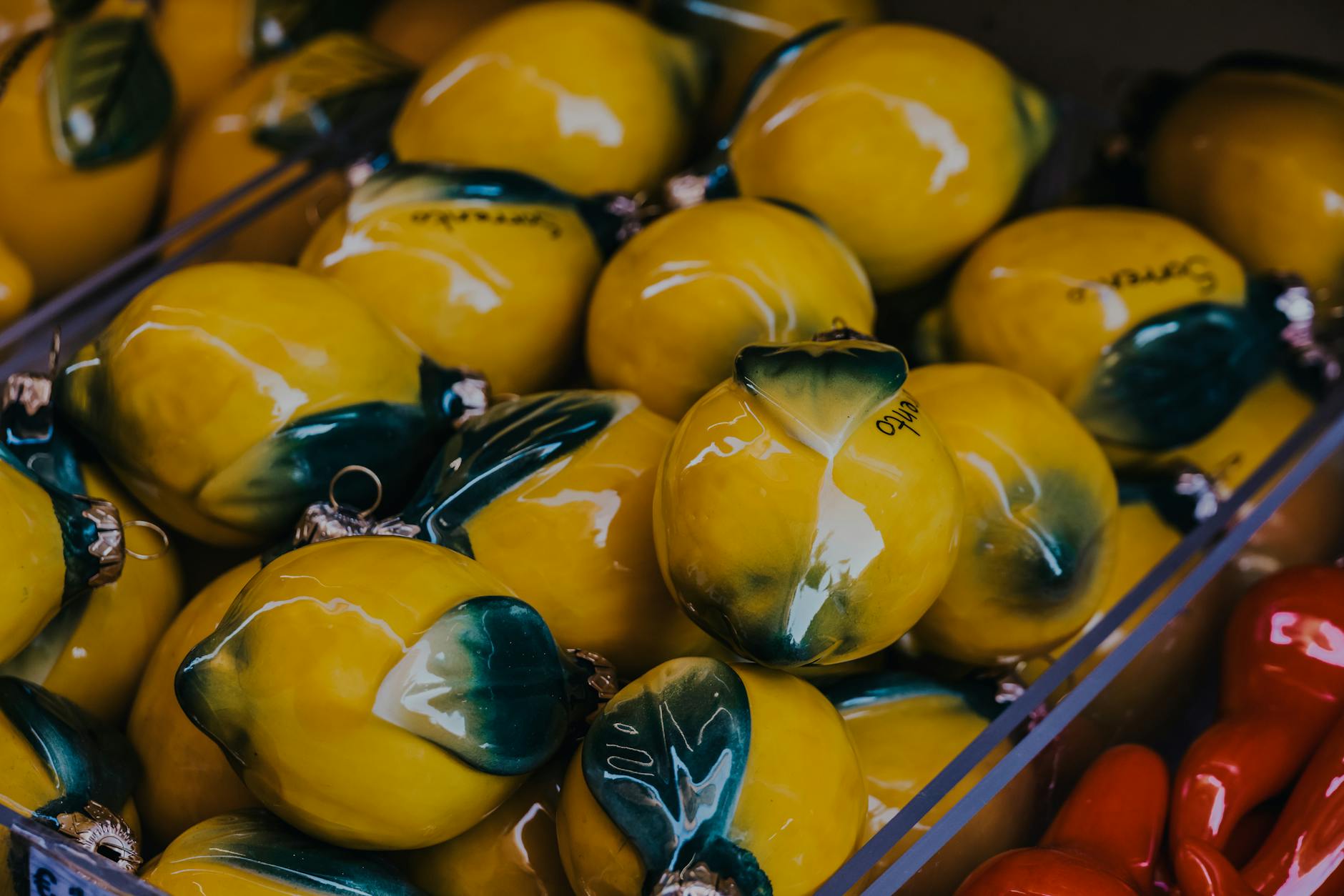 Vibrant yellow ceramic lemons artfully displayed in market setting