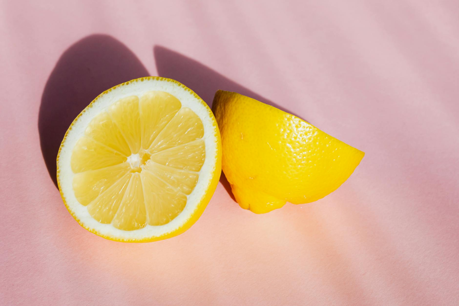 Fresh lemons on a pink background, representing new beginnings and exploration