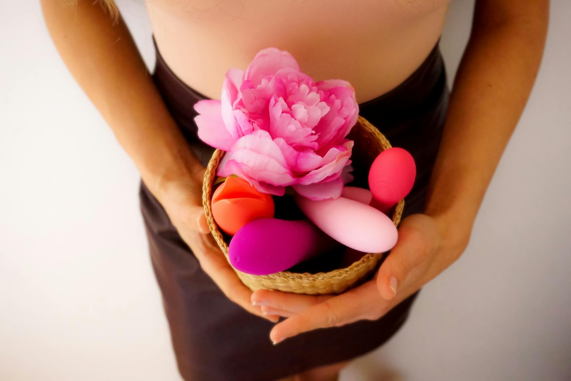 Colorful arrangement of intimate wellness products on a bright yellow background