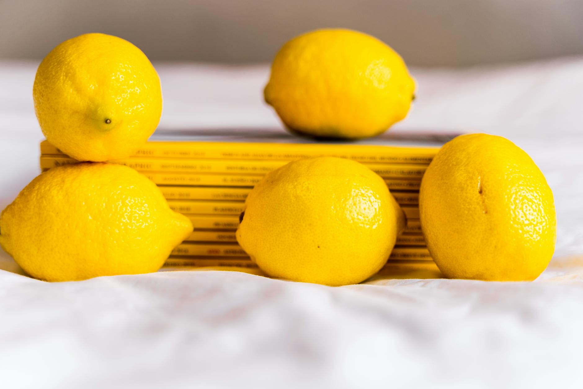 A vibrant collection of colorful lemon-shaped and other intimate wellness devices arranged on a bright yellow surface